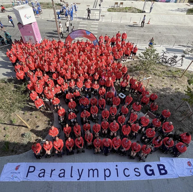 The ParalympicsGB team at the village ready to Parade with the word ParalympicsGB on a huge banner