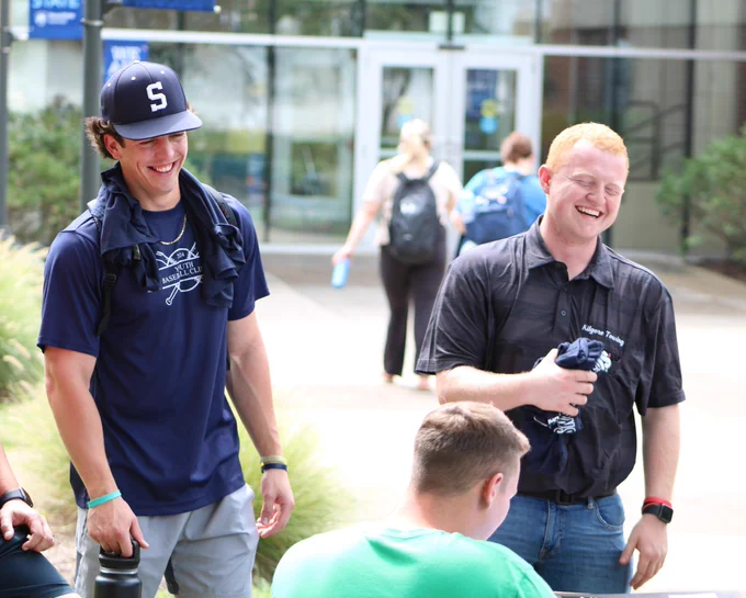 Two students laughing