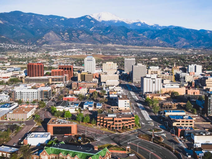 Aerial view of downtown Colorado Springs with Pikes Peak in the background.