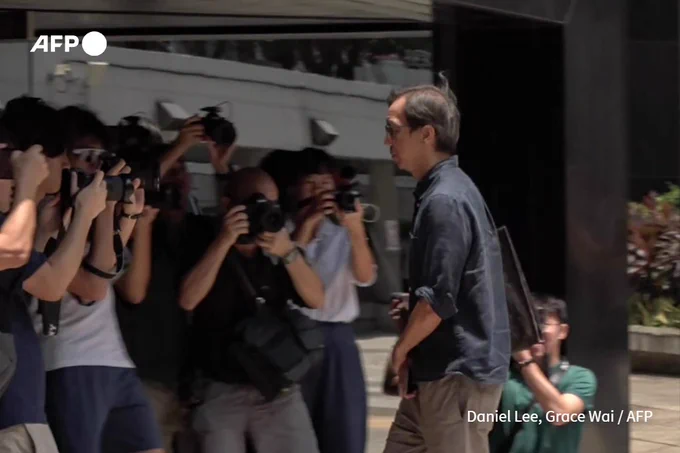 This frame grab from AFPTV video footage shows Chung Pui-kuen (R), the former chief editor of Hong Kong's now shuttered pro-democracy news outlet Stand News, arriving at the Wanchai District Court ahead of a verdict in a landmark sedition trial in Hong Kong on August 29, 2024. A Hong Kong court is expected to rule on August 29 on the sedition charge against pro-democracy media outlet Stand News and its two former chief editors, the first case of its kind since the city came under Chinese rule in 1997. (Daniel Lee, Grace Wai / AFP)