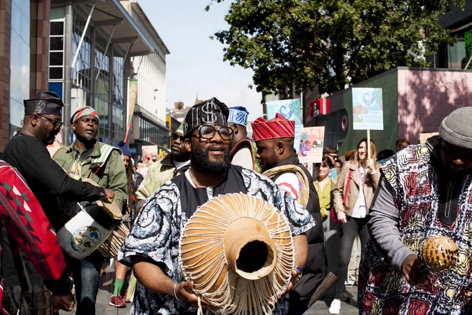 Drummers leading procession through shopping streets