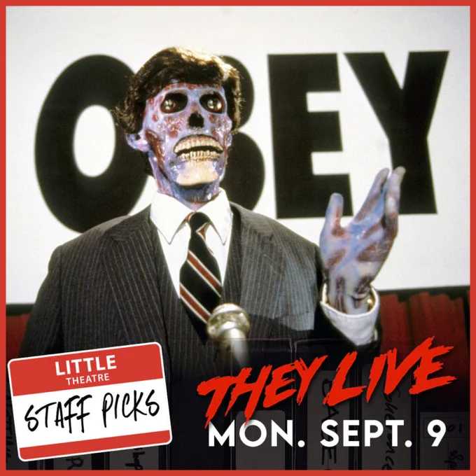 A zombie creature in a suit at a podium in front of a sign that says OBEY