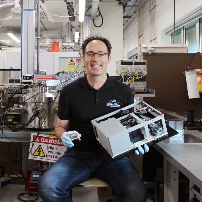 Simeon Barber holding the ProSPA mini lab, credit to The Open University.

