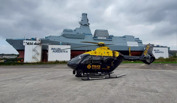 Image of Police Scotland Helicopter with HMS Cardiff in the background.