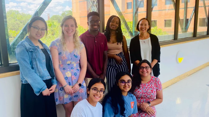 Stephanie Karst and seven research staff smile in a photo from summer 2023.