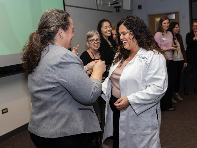 Rush nursing alum Delilah Flexas receives her pin from Rush nursing faculty. 