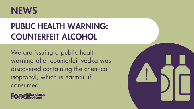 News banner stating a public health warning from Food Standards Scotland about counterfeit alcohol containing harmful isopropyl. Includes graphic of bottles and warning symbol.