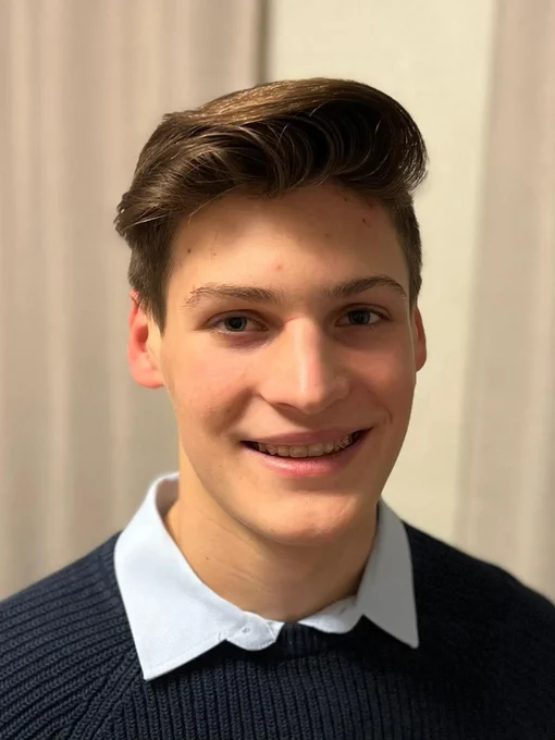 Tristan Hall | Mechatronics Engineering Student wearing a blue formal shirt and smiling at the camera.