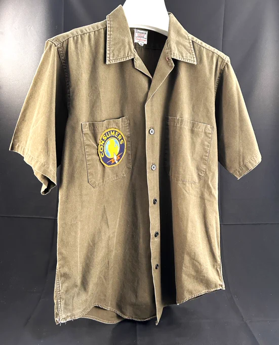 A brown button up t-shirt with a Consumers Energy Logo on the pocket.