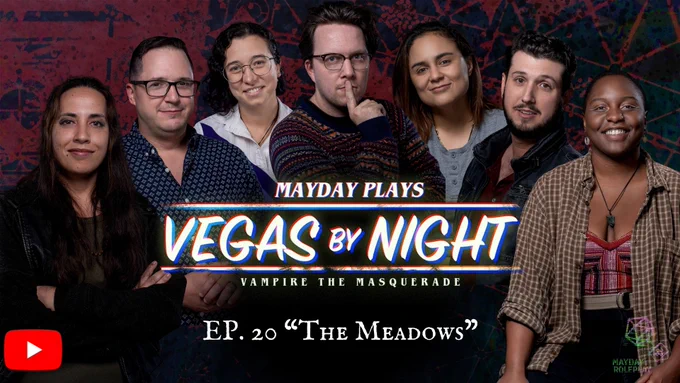 A maroon and navy background. The cast in an arc around the words "Mayday Plays Vegas by Night Vampire the Masquerade. Ep. 20 "The Meadows." Order of cast from left to right, Eli, Vince, Lev, Caleb, Amanda, Sergio, Zakiya. 