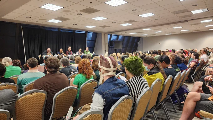 Photo of a full track room, watching a panel of scientists get excited about winr pairings