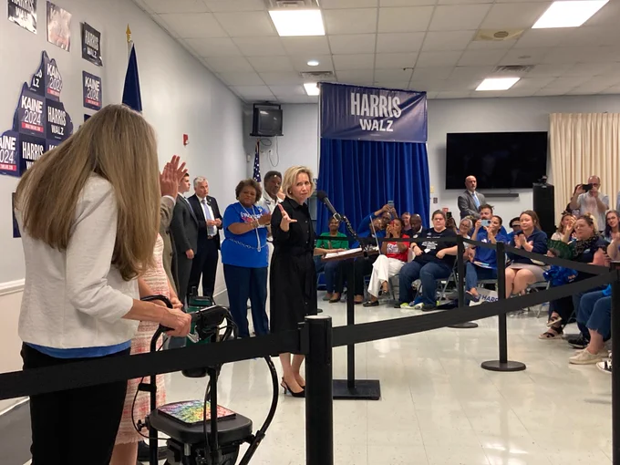 Minnesota First Lady Gwen Walz motions to Rep. Jennifer Wexton.