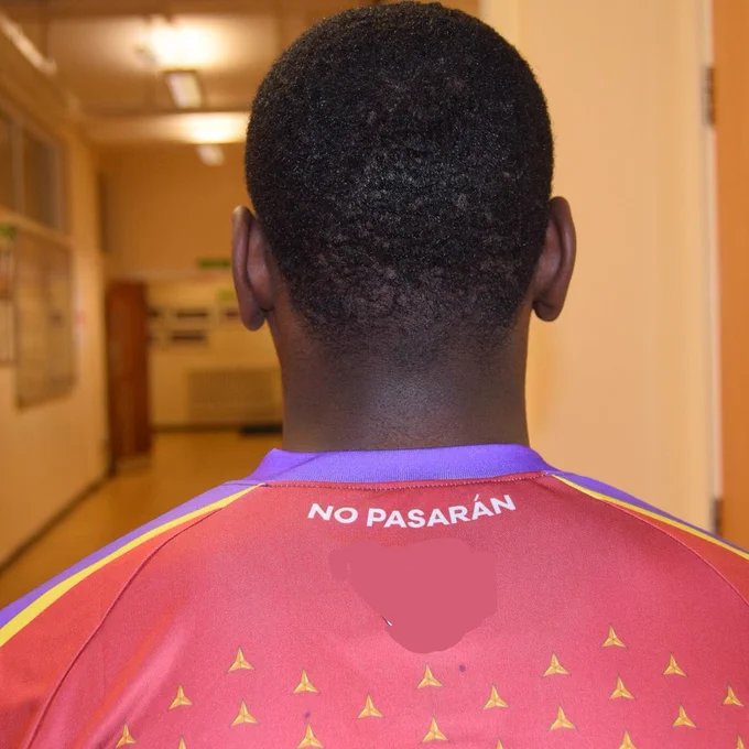 Divin Mubama in a Clapton CFC shirt - pictured from behind