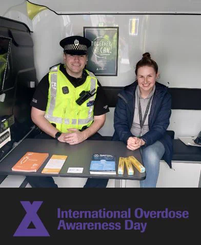 Pictre of PC Murphy with a member of the Forth Valley Transform team with a banner underneath which says International Overdose Awareness in purple