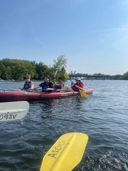 Four people in two red kayaks
