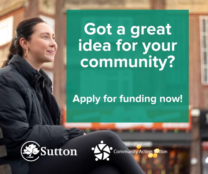 Colour photograph shows a young woman aged in her twenties with dark hair pulled back into a ponytail, wearing gold hoop earrings, a black jacket and leggings. She sits in front of a row of buildings. A green box with copy saying got a great idea for your community? Apply for funding now. It shows the logs for Sutton Council and Community Action Sutton
