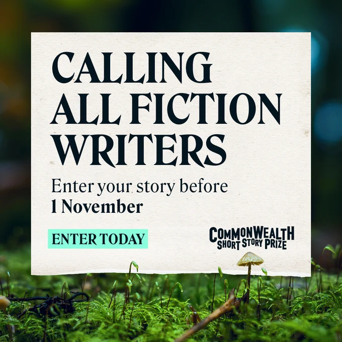 Advertisement for the Commonwealth Short Story Prize. The sign reads 'Calling All Fiction Writers. Enter your story before 1 November. Enter Today.' It is placed on grass with a blurred green background.