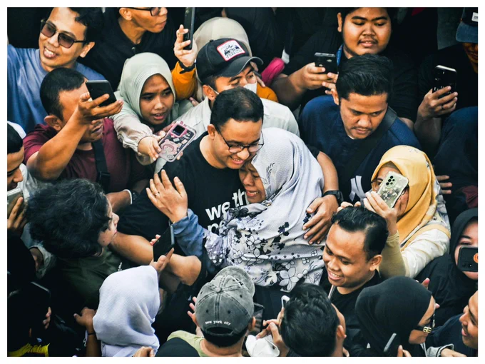 Seorang ibu berhijab terlihat menangis dan memeluk Anies di antara kerumunan orang-orang di CFD Jakarta.
