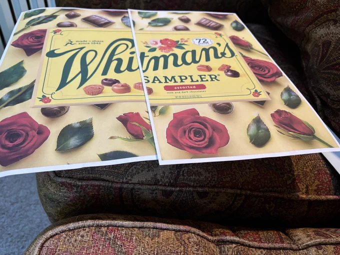 Print out of Whitman’s Sampler photo sitting on a box.
