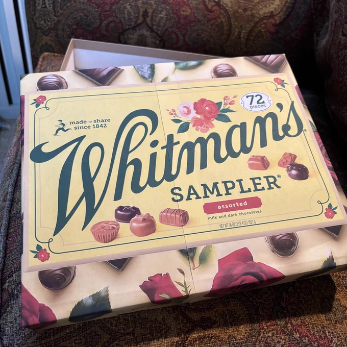 Box lid covered with printout of Whitman’s Sampler box photo.