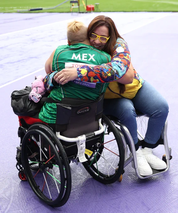 Bronze medalist, Rosa Maria Guerrero Cazares of Team Mexico and gold medalist, Erica Maria Castano Salazar of Team Colombia, embrace following the Women's Discus Throw F55 Final on day two of the Paris 2024 Summer Paralympic Games at Stade de France on August 30, 2024 in Paris, France. (Photo by Ezra Shaw/Getty Images)