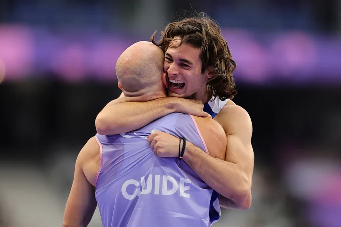 Antanasios Ghavelas of Team Greece hugs guide Ioannis Nyfantopoulos of Team Greece after their victory during the Men's 100m T11 Final on day eight of the Paris 2024 Summer Paralympic Games at Stade de France on September 05, 2024 in Paris, France. (Photo by Alex Slitz/Getty Images)