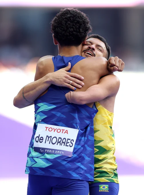 Thomaz Ruan De Moraes of Team Brazil (L) and Petrucio Ferreira Dos Santos of Team Brazil (R) embrace following the Men's 400mm T47 Round 1 Heats on day nine of the Paris 2024 Summer Paralympic Games at Paris La Defense Arena on September 06, 2024 in Nanterre, France. (Photo by Steph Chambers/Getty Images)