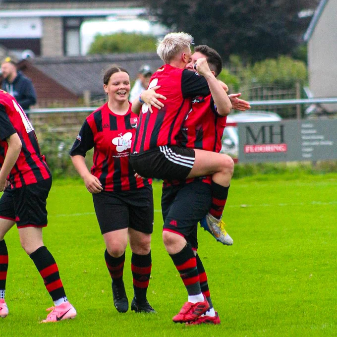 An image of Redruth Women's team celebrating after winning their Adobe Women's FA Cup first round qualifying game