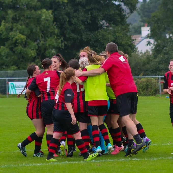 An image of Redruth Women's team celebrating after winning their Adobe Women's FA Cup first round qualifying game