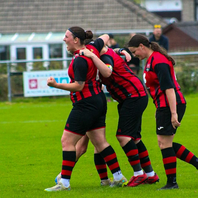 An image of Redruth Women's team celebrating after winning their Adobe Women's FA Cup first round qualifying game