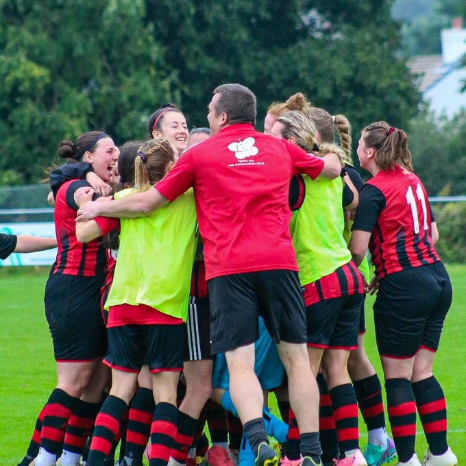 An image of Redruth Women's team celebrating after winning their Adobe Women's FA Cup first round qualifying game