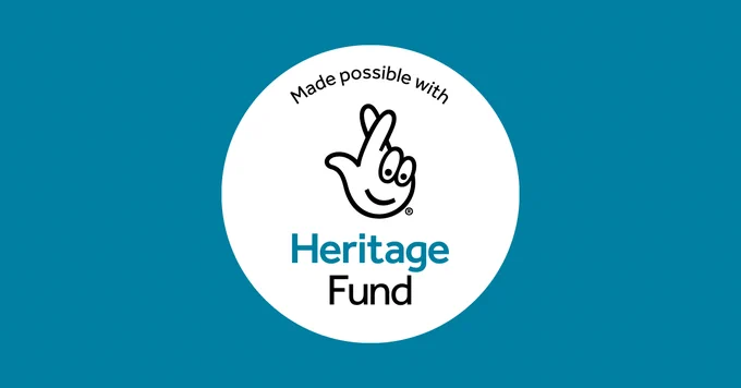 A blue banner with a white circle and the National Lottery's logo in the middle. The text reads "Made possible with Heritage Fund."