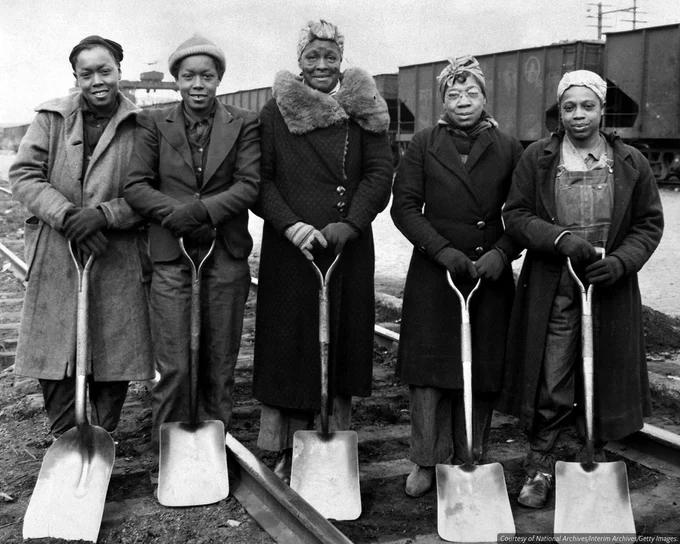 A black-and-white group portrait showing five African American women working with the Baltimore & Ohio railroad as track women, 1943. B & O Railroad. They helped maintain and inspect railroad tracks. 