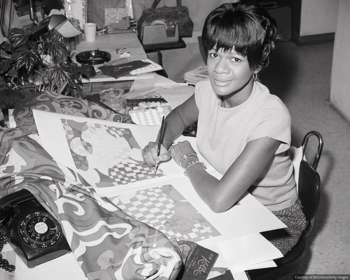 A black-and-white photograph of Jacqueline Peters, the daughter of a Pullman car waiter, working as chief fabrics stylist for a major textile house.