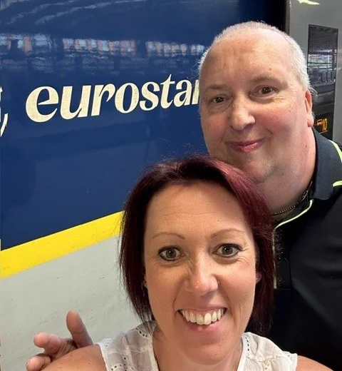Andrew and Sara standing in front of the Eurostar train.