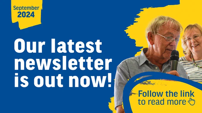 Blue graphic with text that reads 'September 2024 - our latest newsletter is out now - Follow the link to read more'. On the right of the graphic is an image of a man speaking into a microphone.