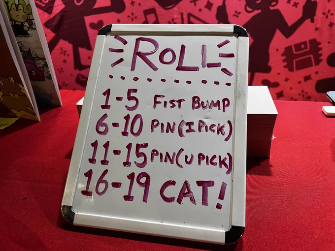A whiteboard reading:
ROLL
1-5 Fist Bump
6-10 Pin (I Pick)
11-15 Pin (U Pick)
16-19 CAT!
(I don't know what happens at 20???)