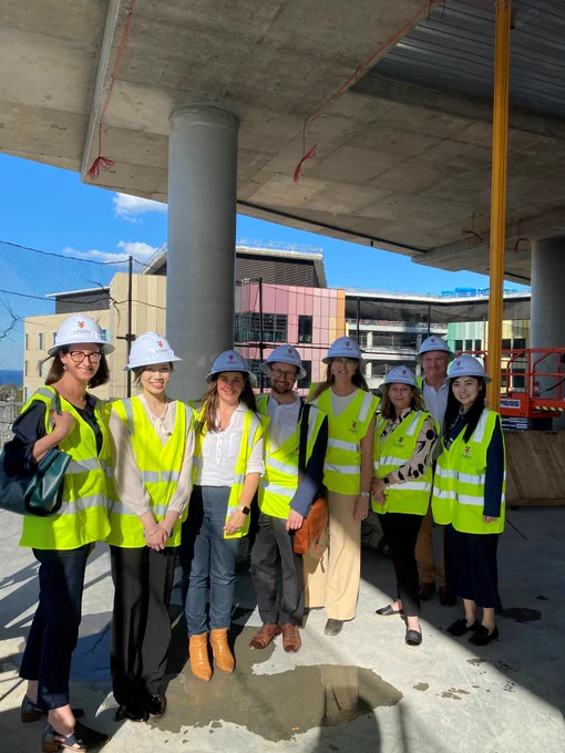 Paula Katalinic, Sheila Lam, Tracy Kane, Ben Ashby, Lisa Keay, Gail Giordani, Craig Stamp and Sephora Miao with hard hats on touring the Health Translation Hub