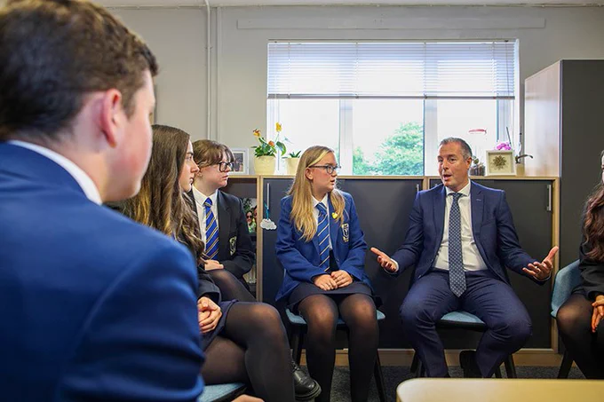 Students from St Columbanus Bangor chatting to Education Minister Paul GIvan