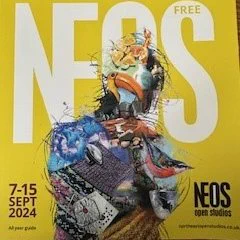Front cover of North East Open Studios brochure.  It is mainly yellow coloured with white writing and includes a creative picture and the dates, additional text and the web address.