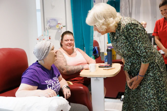 Her Majesty The Queen speaks with a patient undergoing chemotherapy treatment.