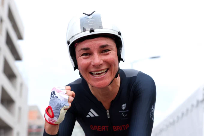 Sarah storey smiling close up making a fist at the finish line looking down the camera lens