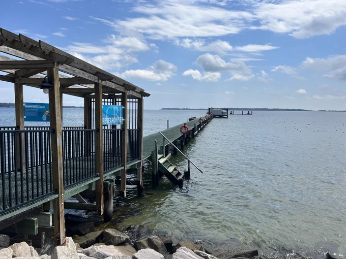 A research pier extends out into the water.
