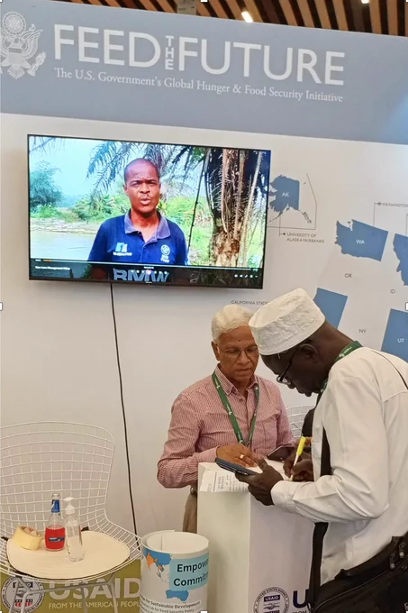 Fish Innovation Lab Africa Regional Coordinator Sunil Siriwardena talks with a participant at the Africa Food Systems Forum 2024 Summit