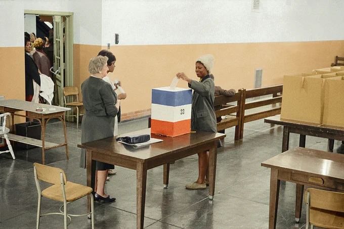 "Woman voting in Cardoza High School in Washington, D.C." Original black and white negative by Marion S. Trikosko. Taken November 3, 1964. Colorized by Jordan J. Lloyd. Library of Congress, Prints and Photographs Division. Photo by Unseen Histories on Unsplash.