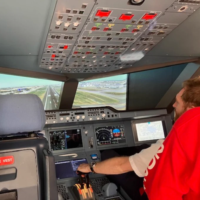 Image of two flight instructors sat in a plane mid-flight