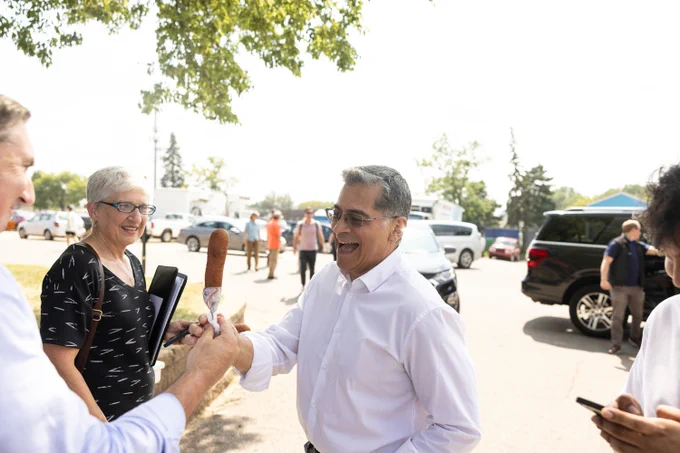 Secretary Becerra eating corndog 