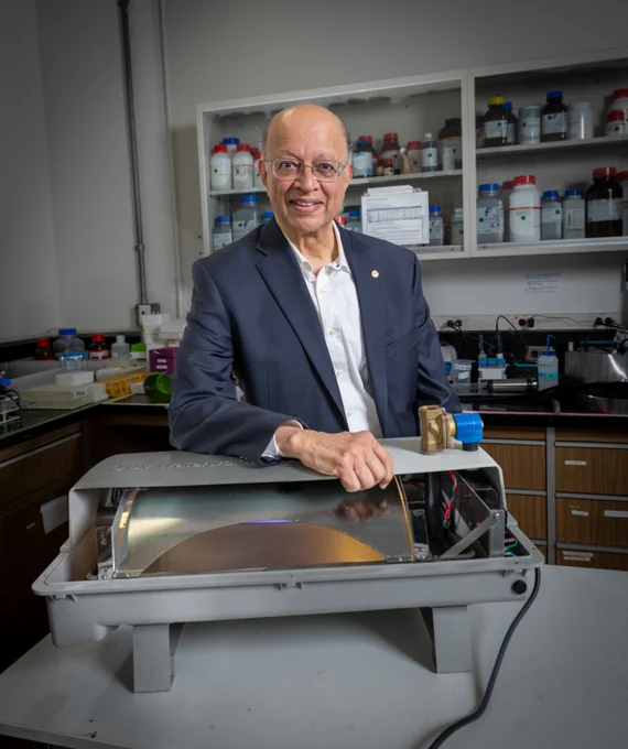 Ashok Gadgil photographed with the UV Waterworks device, a low-cost and efficient water purifier that utilizes ultra-violet light to render viruses and bacteria harmless, at his lab on the UC Berkeley campus.