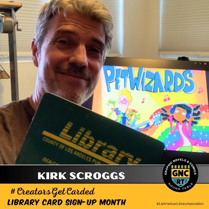 Comics creator Kirk Scroggs smiling and holding their library card and in front of a monitor displaying their book, PETWIZARDS.