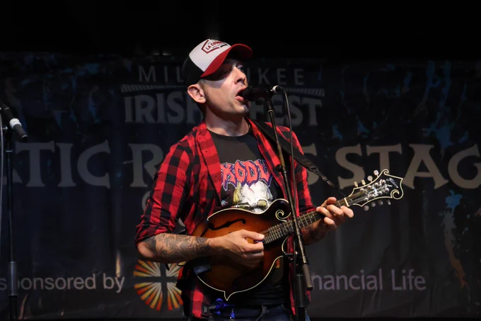 Man singing and playing mandolin